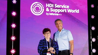 Janice Smith on stage with Kirk Weisler accepting the award for Best Service & Support Manager